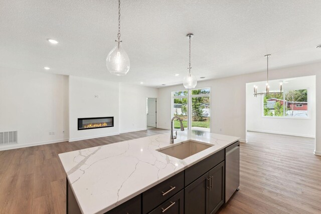 17729 Everest Ave, Lakeville, MN 55044 - kitchen with a sink, stainless steel dishwasher, open floor plan, decorative light fixtures, and recessed lighting