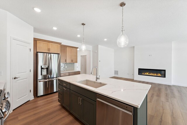 17729 Everest Ave, Lakeville, MN 55044 - kitchen featuring appliances with stainless steel finishes, a sink, wood finished floors, hanging light fixtures, and recessed lighting