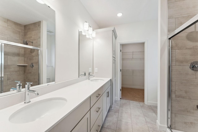 17729 Everest Ave, Lakeville, MN 55044 - full bathroom featuring a stall shower, double vanity, a spacious closet, tile patterned floors, and toilet