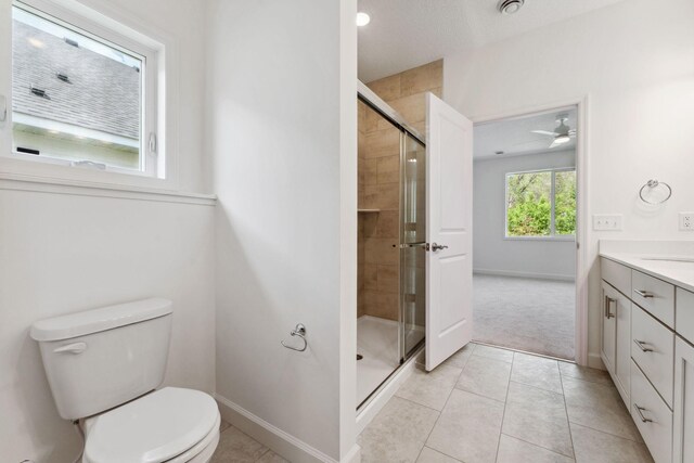 17729 Everest Ave, Lakeville, MN 55044 - bathroom featuring vanity, toilet, a stall shower, baseboards, and a ceiling fan