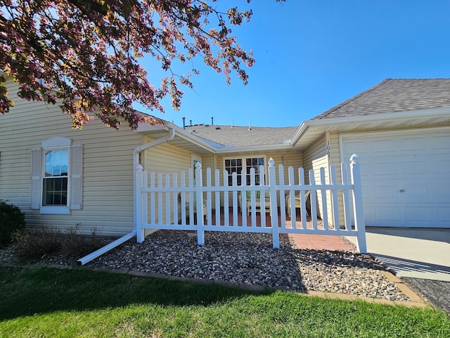 1065 Blackbird Trl SW Unit 8, Hutchinson, MN 55350 - view of front of house with a garage, fence, and a shingled roof