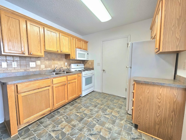 1065 Blackbird Trl SW Unit 8, Hutchinson, MN 55350 - kitchen featuring white appliances, a sink, decorative backsplash, a textured ceiling, and dark stone finish flooring