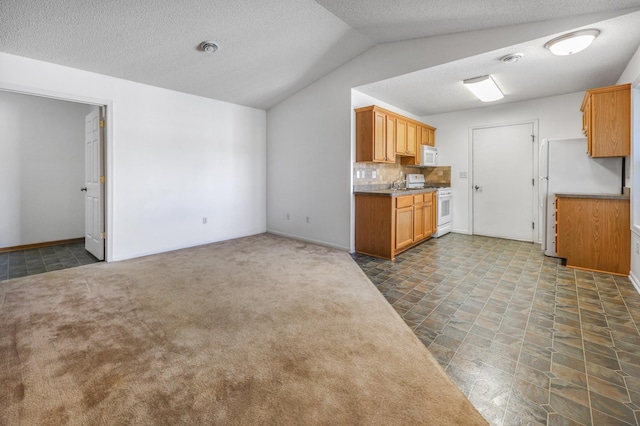 1065 Blackbird Trl SW Unit 8, Hutchinson, MN 55350 - kitchen featuring white appliances, vaulted ceiling, tasteful backsplash, a textured ceiling, and baseboards