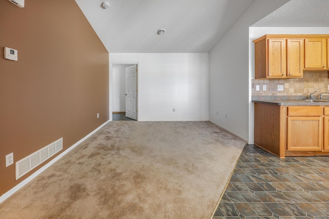 1065 Blackbird Trl SW Unit 8, Hutchinson, MN 55350 - kitchen with lofted ceiling, tasteful backsplash, a sink, dark carpet, and baseboards