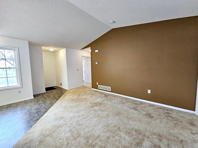 1065 Blackbird Trl SW Unit 8, Hutchinson, MN 55350 - unfurnished room with a textured ceiling, baseboards, vaulted ceiling, and a smoke detector