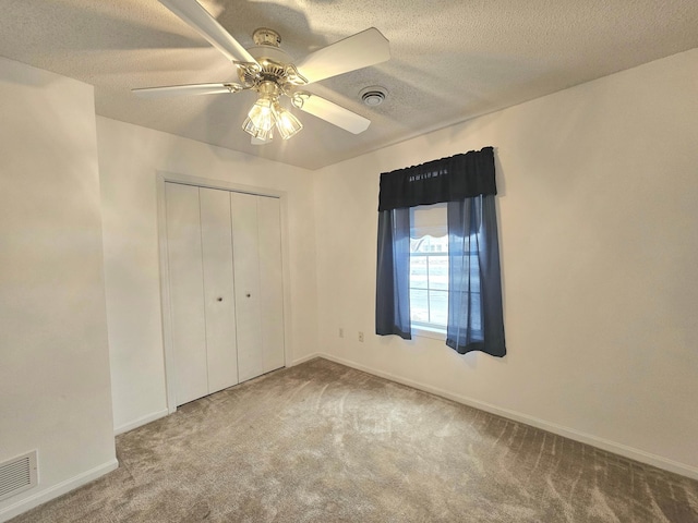 1065 Blackbird Trl SW Unit 8, Hutchinson, MN 55350 - unfurnished bedroom featuring carpet, a closet, baseboards, a textured ceiling, and ceiling fan