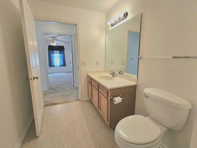 1065 Blackbird Trl SW Unit 8, Hutchinson, MN 55350 - bathroom with vanity, toilet, baseboards, and a ceiling fan