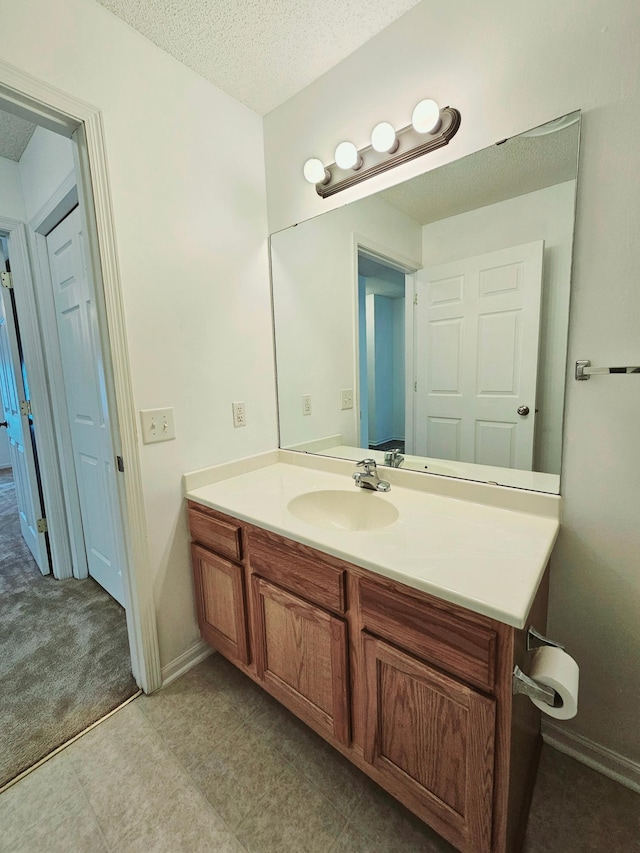 1065 Blackbird Trl SW Unit 8, Hutchinson, MN 55350 - bathroom featuring vanity, a textured ceiling, and baseboards