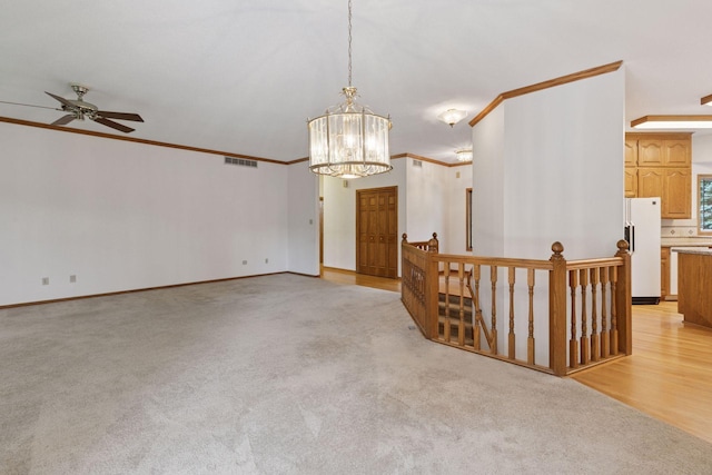 11765 177th St W, Lakeville, MN 55044 - unfurnished room featuring crown molding, a chandelier, a ceiling fan, and light colored carpet