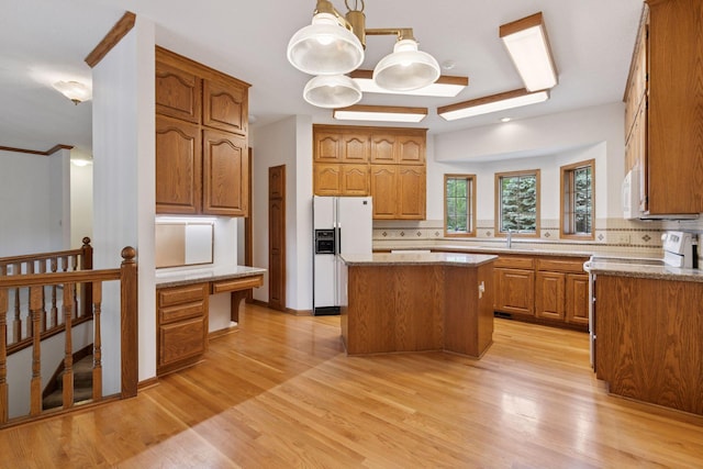 11765 177th St W, Lakeville, MN 55044 - kitchen with white appliances, decorative backsplash, a center island, and brown cabinets