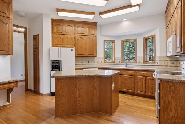 11765 177th St W, Lakeville, MN 55044 - kitchen featuring white appliances, backsplash, a center island, light wood-style floors, and recessed lighting