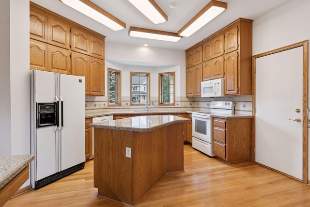 11765 177th St W, Lakeville, MN 55044 - kitchen with white appliances, backsplash, and light wood-style floors
