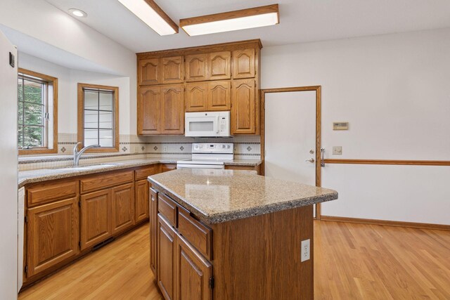 11765 177th St W, Lakeville, MN 55044 - kitchen with white appliances, light wood-style floors, backsplash, and a kitchen island