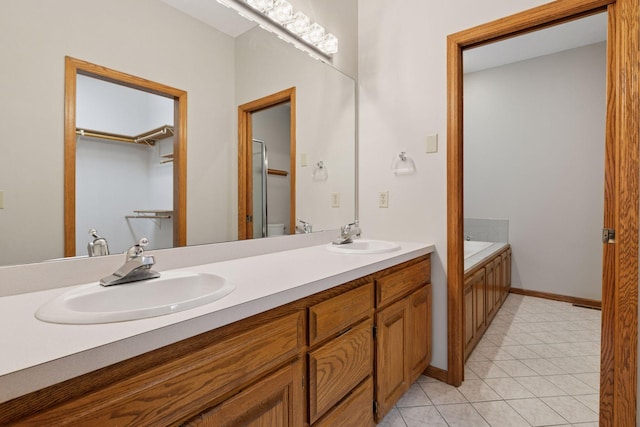 11765 177th St W, Lakeville, MN 55044 - bathroom with double vanity, tile patterned flooring, a garden tub, and a spacious closet