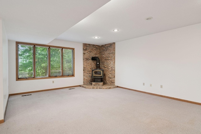 11765 177th St W, Lakeville, MN 55044 - unfurnished living room featuring a wood stove, carpet floors, and recessed lighting