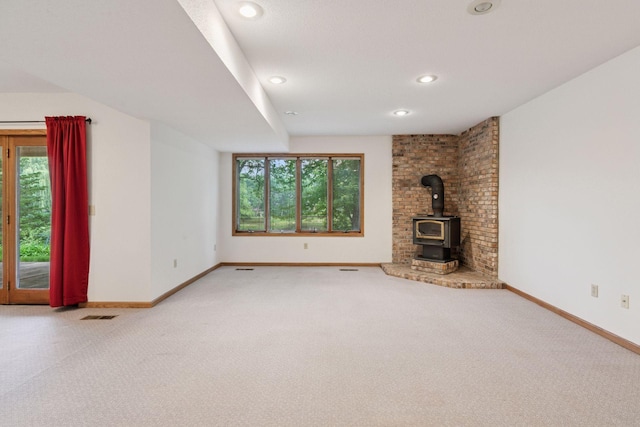 11765 177th St W, Lakeville, MN 55044 - unfurnished living room with healthy amount of natural light, a wood stove, carpet flooring, and recessed lighting