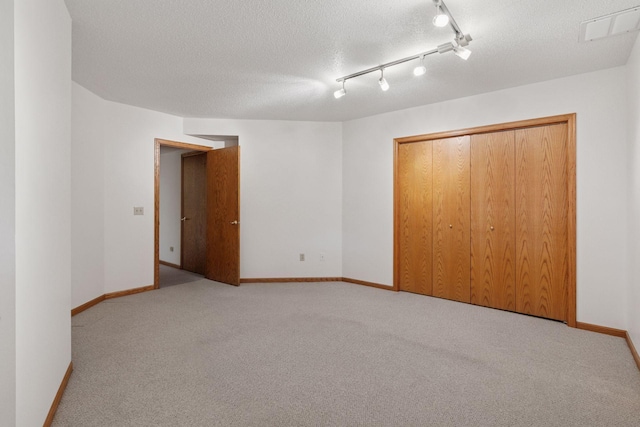 11765 177th St W, Lakeville, MN 55044 - unfurnished bedroom featuring carpet, a closet, and a textured ceiling