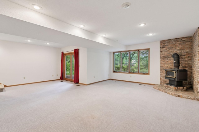 11765 177th St W, Lakeville, MN 55044 - unfurnished living room featuring light carpet, plenty of natural light, a wood stove, and recessed lighting