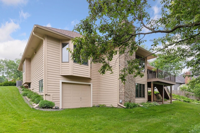 11765 177th St W, Lakeville, MN 55044 - back of house with a garage, a yard, and a wooden deck
