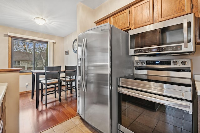 kitchen featuring appliances with stainless steel finishes and light tile patterned floors