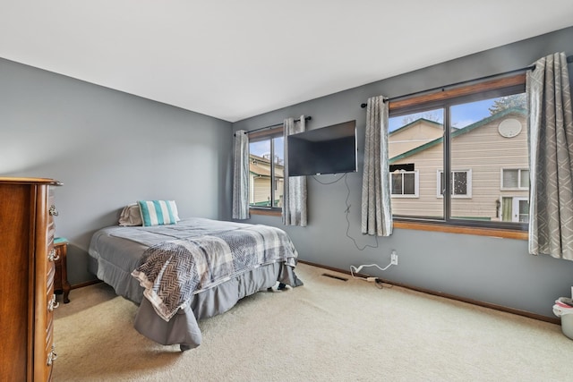 bedroom featuring baseboards, carpet flooring, and visible vents
