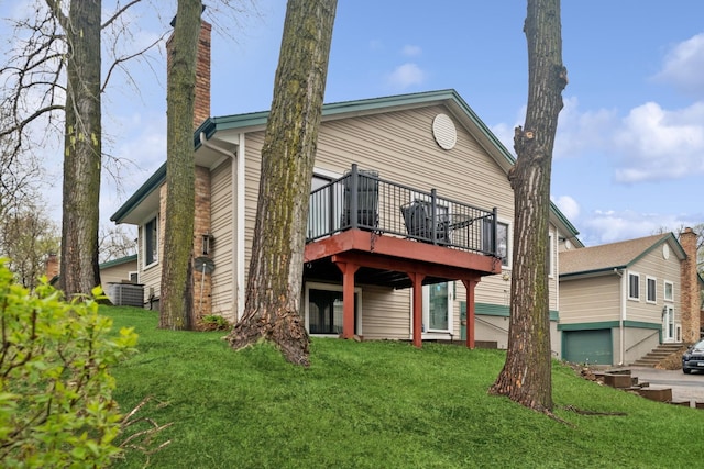 exterior space featuring a wooden deck, a chimney, and a front yard