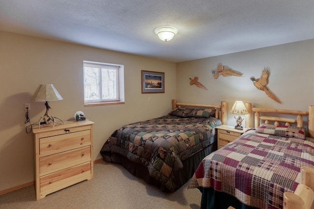 bedroom featuring baseboards, light colored carpet, and a textured ceiling