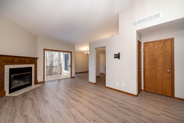 130 Teton Ln Unit 8, Mankato, MN 56001 - unfurnished living room featuring wood finished floors, a fireplace, and a chandelier