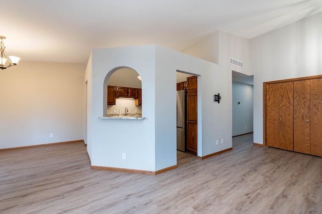 130 Teton Ln Unit 8, Mankato, MN 56001 - unfurnished living room with light wood-type flooring and a chandelier