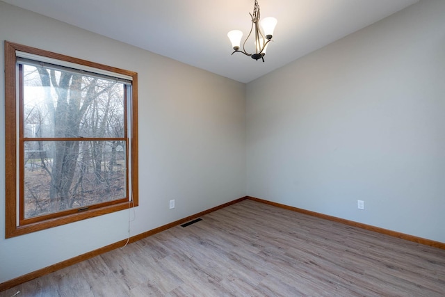 130 Teton Ln Unit 8, Mankato, MN 56001 - spare room featuring wood finished floors and a chandelier