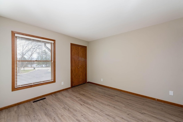 130 Teton Ln Unit 8, Mankato, MN 56001 - spare room featuring light wood-style flooring and baseboards