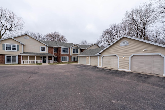130 Teton Ln Unit 8, Mankato, MN 56001 - view of front of property featuring community garages, brick siding, and a porch
