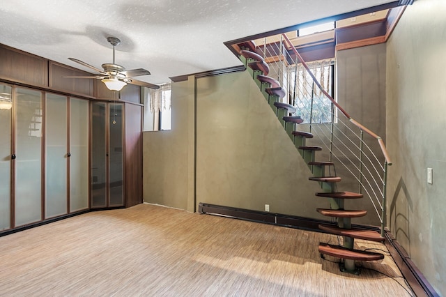 1801 Elliot Ave Unit 4And 6, Minneapolis, MN 55404 - basement featuring a ceiling fan, stairway, and a textured ceiling