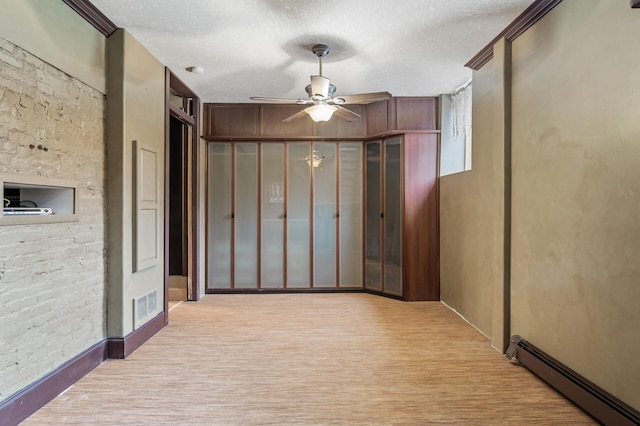 1801 Elliot Ave Unit 4And 6, Minneapolis, MN 55404 - spare room with baseboard heating, a ceiling fan, and a textured ceiling