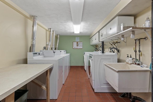 1801 Elliot Ave Unit 4And 6, Minneapolis, MN 55404 - laundry area with washer and dryer, dark tile patterned flooring, and cabinet space
