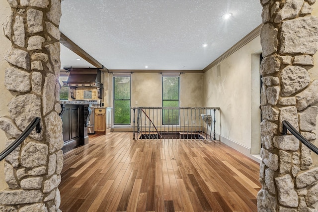 1801 Elliot Ave Unit 4And 6, Minneapolis, MN 55404 - living room featuring light wood finished floors, ornamental molding, a textured ceiling, a fireplace, and recessed lighting