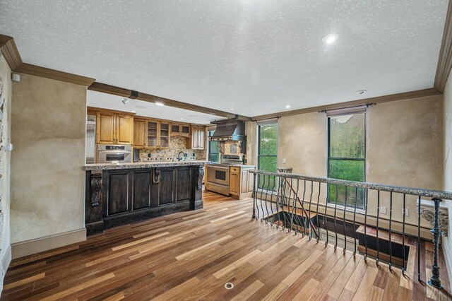 1801 Elliot Ave Unit 4And 6, Minneapolis, MN 55404 - kitchen with appliances with stainless steel finishes, a textured ceiling, light wood-style floors, ornamental molding, and premium range hood