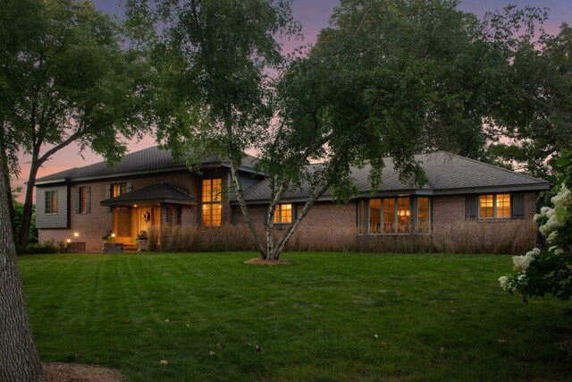 461 Peavey Ln, Wayzata, MN 55391 - back of property at dusk with a yard and brick siding