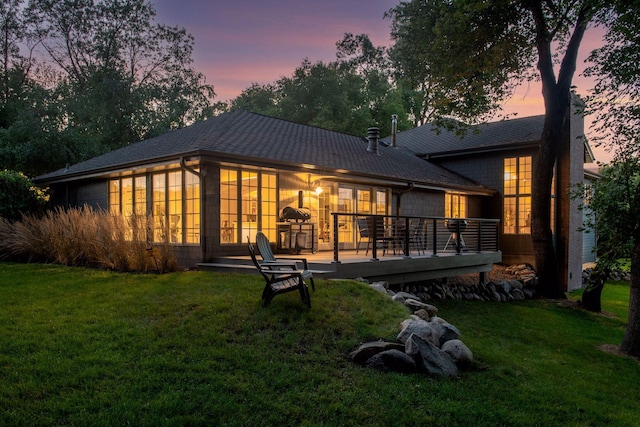 461 Peavey Ln, Wayzata, MN 55391 - back of property at dusk featuring a yard and a wooden deck