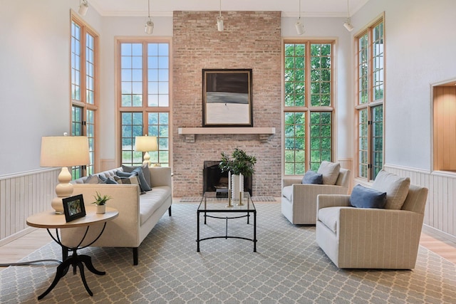 461 Peavey Ln, Wayzata, MN 55391 - living room featuring a brick fireplace, healthy amount of natural light, a wainscoted wall, and a towering ceiling