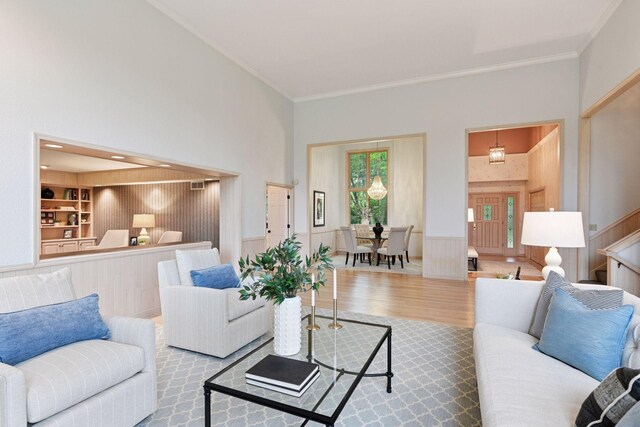 461 Peavey Ln, Wayzata, MN 55391 - living room featuring crown molding, wood finished floors, wainscoting, built in features, and stairs