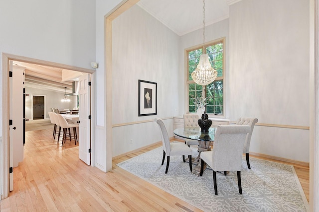 461 Peavey Ln, Wayzata, MN 55391 - dining room featuring crown molding, a chandelier, and wood finished floors