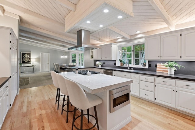 461 Peavey Ln, Wayzata, MN 55391 - kitchen with appliances with stainless steel finishes, island range hood, light wood finished floors, a breakfast bar, and wood ceiling