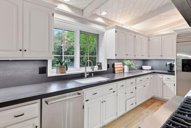 461 Peavey Ln, Wayzata, MN 55391 - kitchen featuring stainless steel appliances, light wood-style flooring, dark countertops, backsplash, and white cabinets