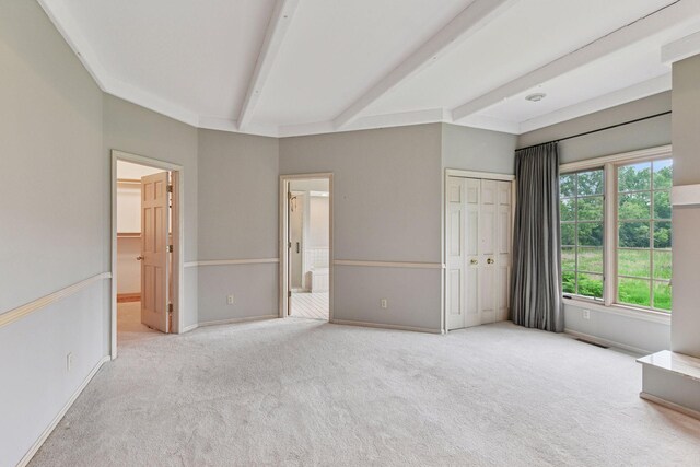 461 Peavey Ln, Wayzata, MN 55391 - unfurnished bedroom with carpet floors, beamed ceiling, a closet, and ensuite bath