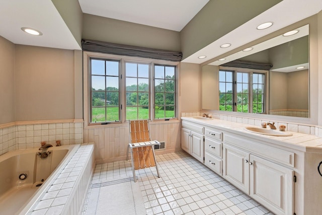 461 Peavey Ln, Wayzata, MN 55391 - full bathroom with double vanity, a wainscoted wall, plenty of natural light, a tub with jets, and recessed lighting