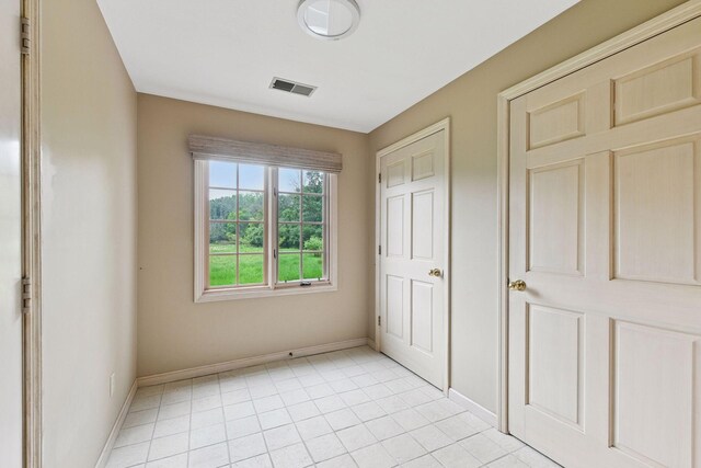 461 Peavey Ln, Wayzata, MN 55391 - unfurnished bedroom with baseboards and light tile patterned floors