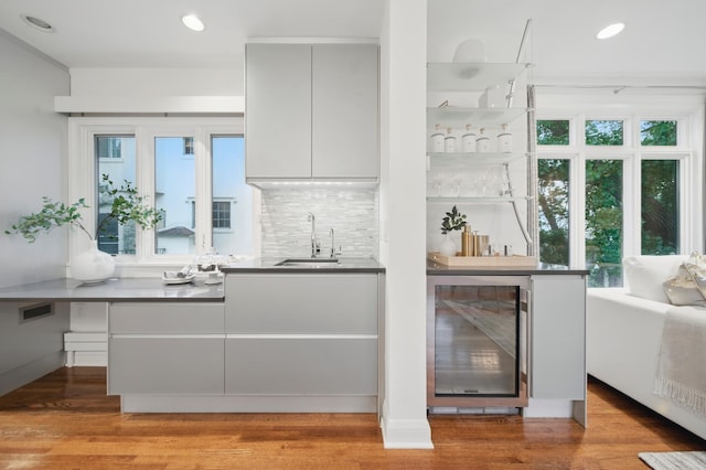 kitchen with wine cooler, a sink, plenty of natural light, and recessed lighting