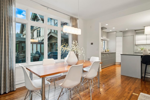 dining room with wood finished floors and recessed lighting