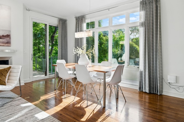 dining space featuring wood finished floors and baseboards